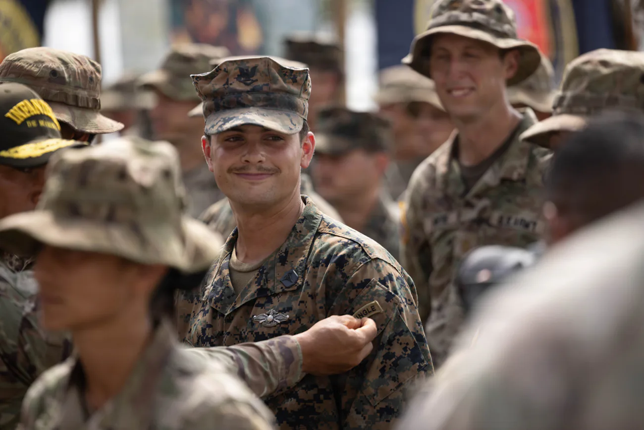 Service members in uniform smiling together