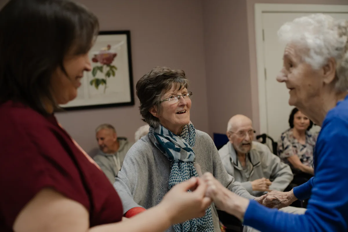 Residents and staff sharing a moment in a senior living community